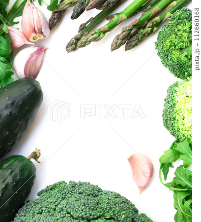 Frame of green vegetables broccoli, arugula, cucumber, asparagus and garlic on white background Frame of green vegetables broccoli, arugula, cucumber, asparagus and garlic on white background 112660168
