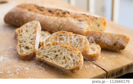 Fresh loaf of bread on wooden board Fresh loaf of bread on wooden board 112660170