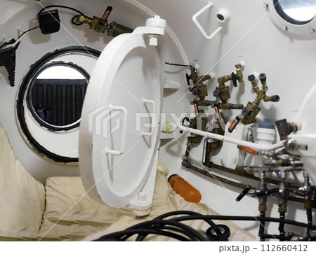 Interior of a white hyperbaric chamber 112660412