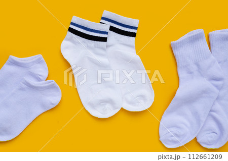 White socks on yellow background. 112661209
