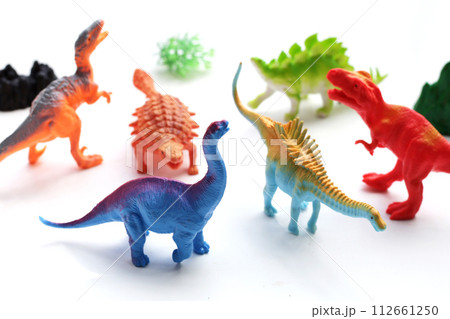 Plastic dinosaur toys on white background. Plastic dinosaur toys on white background. 112661250