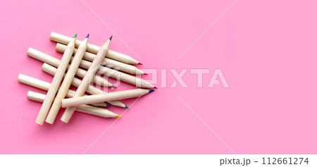 Colorful pencils on pink background. 112661274