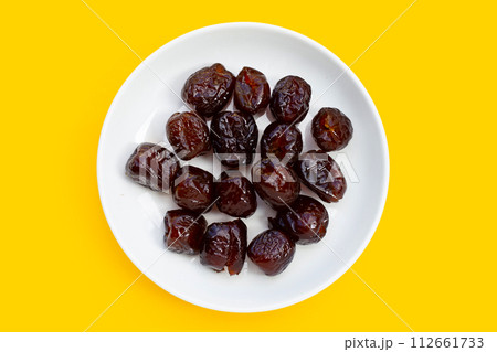 Sweet chinese jujube dessert on yellow background. Sweet chinese jujube dessert on yellow background. 112661733