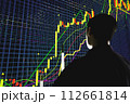 Price movement chart with indicators and volumes. The trader analyzes the price movement on a huge trading chart. A businessman-investor observes an increase in the price of an asset 112661814
