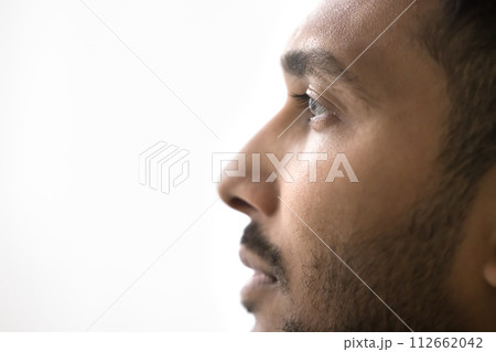 Closeup profile of serious Indian man on white gray background 112662042