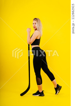 Luxuriously dressed female with a hockey stick. Women's winter sports. 112662915