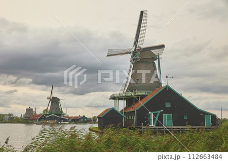 Ancient mill in the evening Zaanstad, Netherlands Ancient mill in the evening Zaanstad, Netherlands 112663484