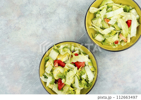 Healthy green salad with fresh vegetables. Healthy green salad with fresh vegetables. 112663497