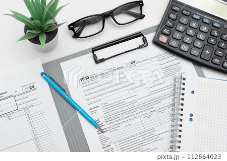 Tax income concept with calculator and pen on desk Tax income concept with calculator and pen on desk 112664023