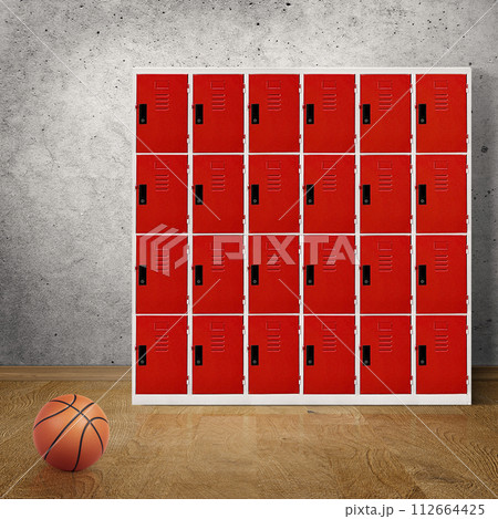 Basketball in room floor with locker in the background 112664425