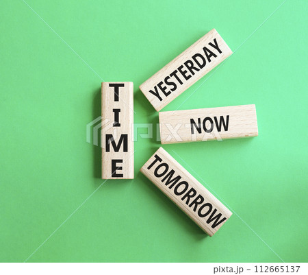 Time - Yesterday Now Tomorrow. Wooden cubes with words Time. Beautiful green background. Business and Time concept. Copy space. 112665137