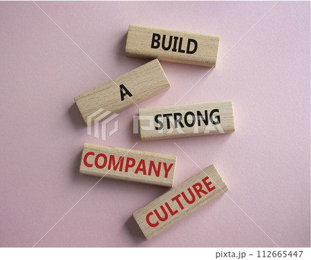 Company culture symbol. Wooden blocks with words Build a strong company culture. Beautiful pink background. Business and Company culture concept. Copy space. Company culture symbol. Wooden blocks with words Build a strong company culture. Beautiful pink background. Business and Company culture concept. Copy space. 112665447