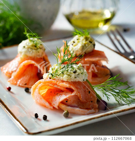 白いプレートに乗せたスモークサーモンのマリネ 112667068