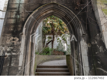The stone arched entrance leads to the stone staircase inside of St Dunstan in the East Church Garden. The stone arched entrance leads to the stone staircase inside of St Dunstan in the East Church Garden. 112667402