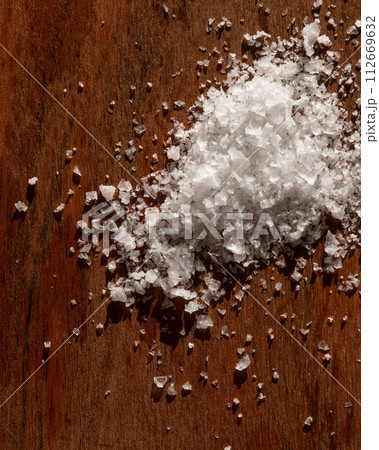 A Pile Of Salt Is On A Wooden Table 112669632