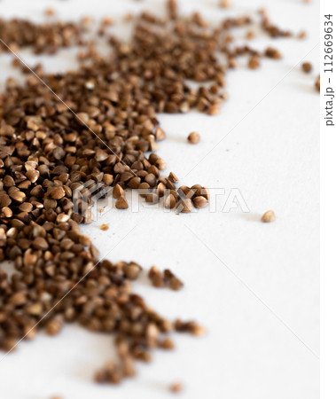 A Pile Of Brown Grains of buckwheat On A White Surface 112669634