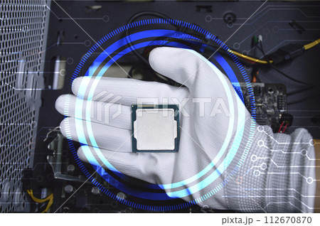 Picture of a hand wearing white gloves with a CPU chip placed on it. 112670870