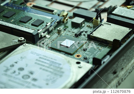 Close-up of a part of a computer motherboard, with many IC chips visible. 112670876