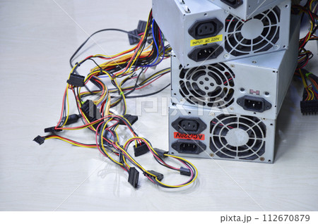 Computer power supply stacked on the floor (old condition) 112670879