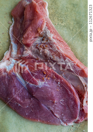 Raw meat on baking paper 112671323