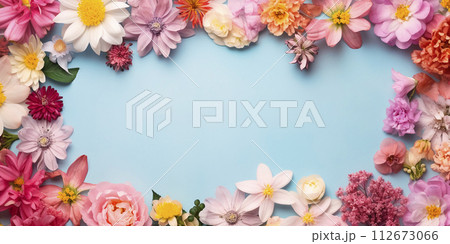 Flat lay composition of spring colorful flowers on a blue background with space for text 112673066