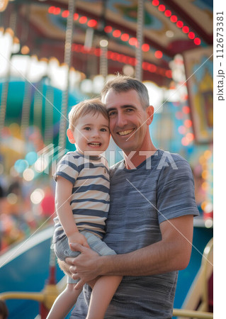 Caucasian father holding son in amusement park. 112673381