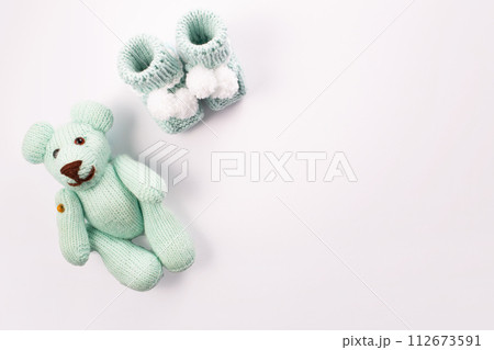 Baby socks and teddy bear on white background. Baby boy birth. Greeting card.Pregnancy announcement. Flatlay, top view Baby socks and teddy bear on white background. Baby boy birth. Greeting card.Pregnancy announcement. Flatlay, top view 112673591