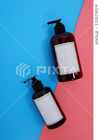 Body care. set of bottles with dispensers on a blue and pink background. Advertising concept 112674824