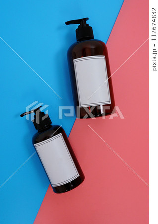 Body care. set of bottles with dispensers on a blue and pink background. Advertising concept 112674832