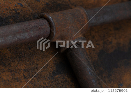 Rusty plumb tube on rusty metal wall Rusty plumb tube on rusty metal wall 112676901