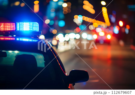 AI-generated content. police car lights at night in city street with selective focus and bokeh 112679607