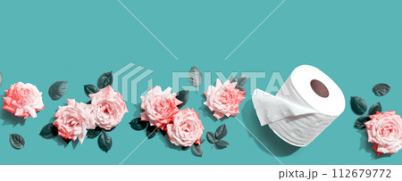Toilet paper with pink roses overhead view 112679772