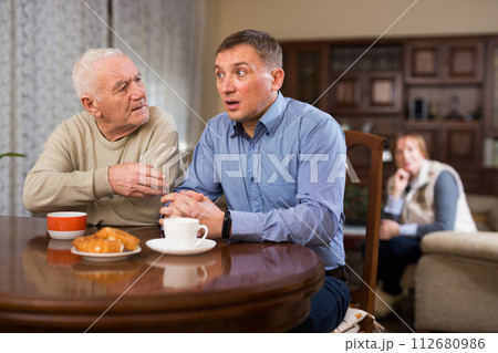Man spending time with his senior parents Man spending time with his senior parents 112680986