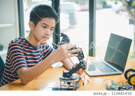 Asian boy learning and studying the work of technology robots.homeschool and science for tech project. playing childhood kids hobby leisure lifestyle people toys robotics technology. Asian boy learning and studying the work of technology robots.homeschool and science for tech project. playing childhood kids hobby leisure lifestyle people toys robotics technology. 112681410