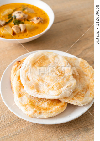 Chicken curry soup with roti Chicken curry soup with roti 112686808