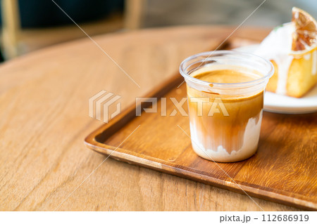 Dirty Coffee - A glass of espresso shot mixed with cold fresh milk Dirty Coffee - A glass of espresso shot mixed with cold fresh milk 112686919