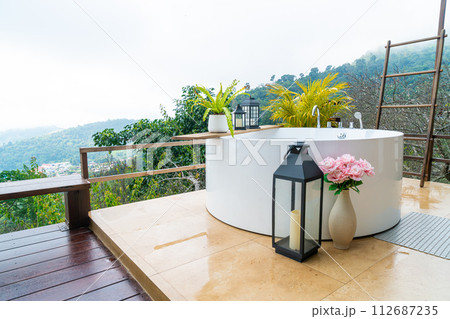 outdoor bath tub with beautiful mountain view background 112687235