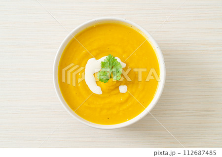 pumpkin soup in white bowl pumpkin soup in white bowl 112687485