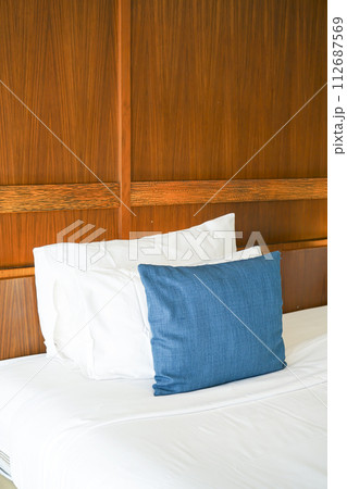 comfortable pillows and white pillows on bed 112687569