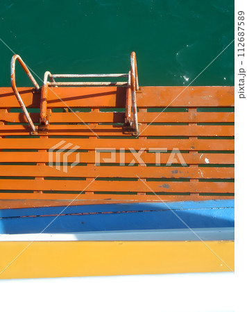 Wooden boat steps to the sea under a summer sky Wooden boat steps to the sea under a summer sky 112687589