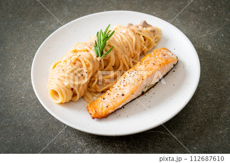 grilled salmon with spaghetti creamy tomato sauce 112687610