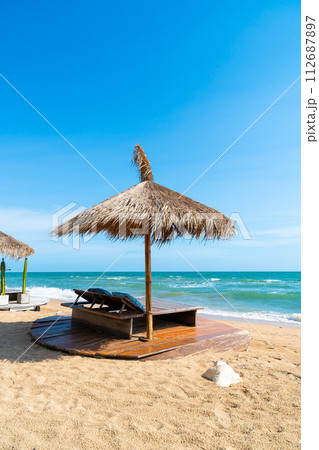 beach chair and umbrella with sea beach background beach chair and umbrella with sea beach background 112687897