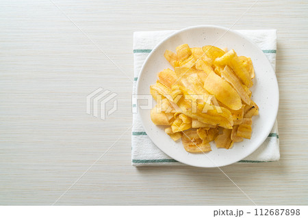 Banana Chips - fried or baked sliced banana 112687898