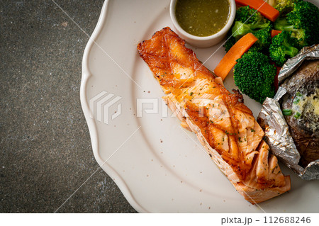 grilled salmon steak with bake potato 112688246