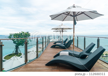 bed pool with umbrella around swimming pool bed pool with umbrella around swimming pool 112688311