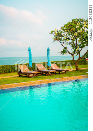 chair pool and umbrella around swimming pool chair pool and umbrella around swimming pool 112688315