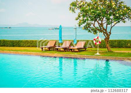 chair pool and umbrella around swimming pool chair pool and umbrella around swimming pool 112688317