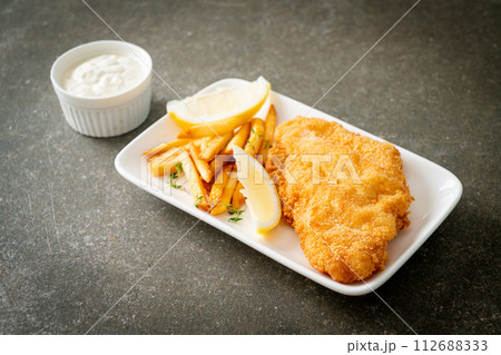 fish and chips - fried fish fillet with potatoes chips 112688333