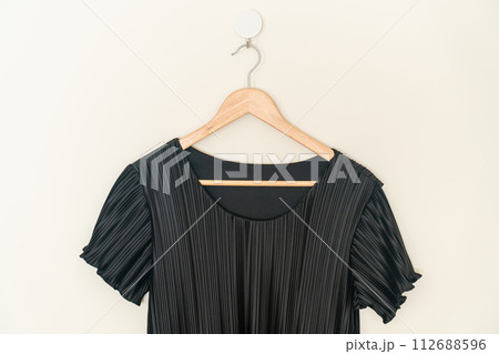beautiful black dress hanging on wall beautiful black dress hanging on wall 112688596