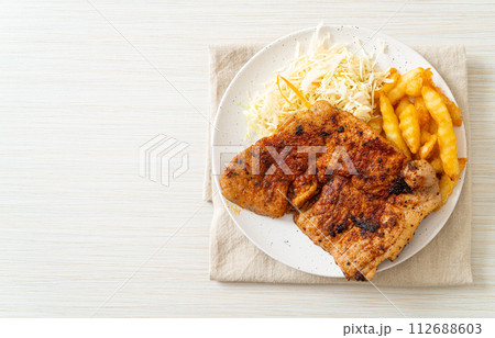 grilled spicy barbecue pork steak with french fries grilled spicy barbecue pork steak with french fries 112688603